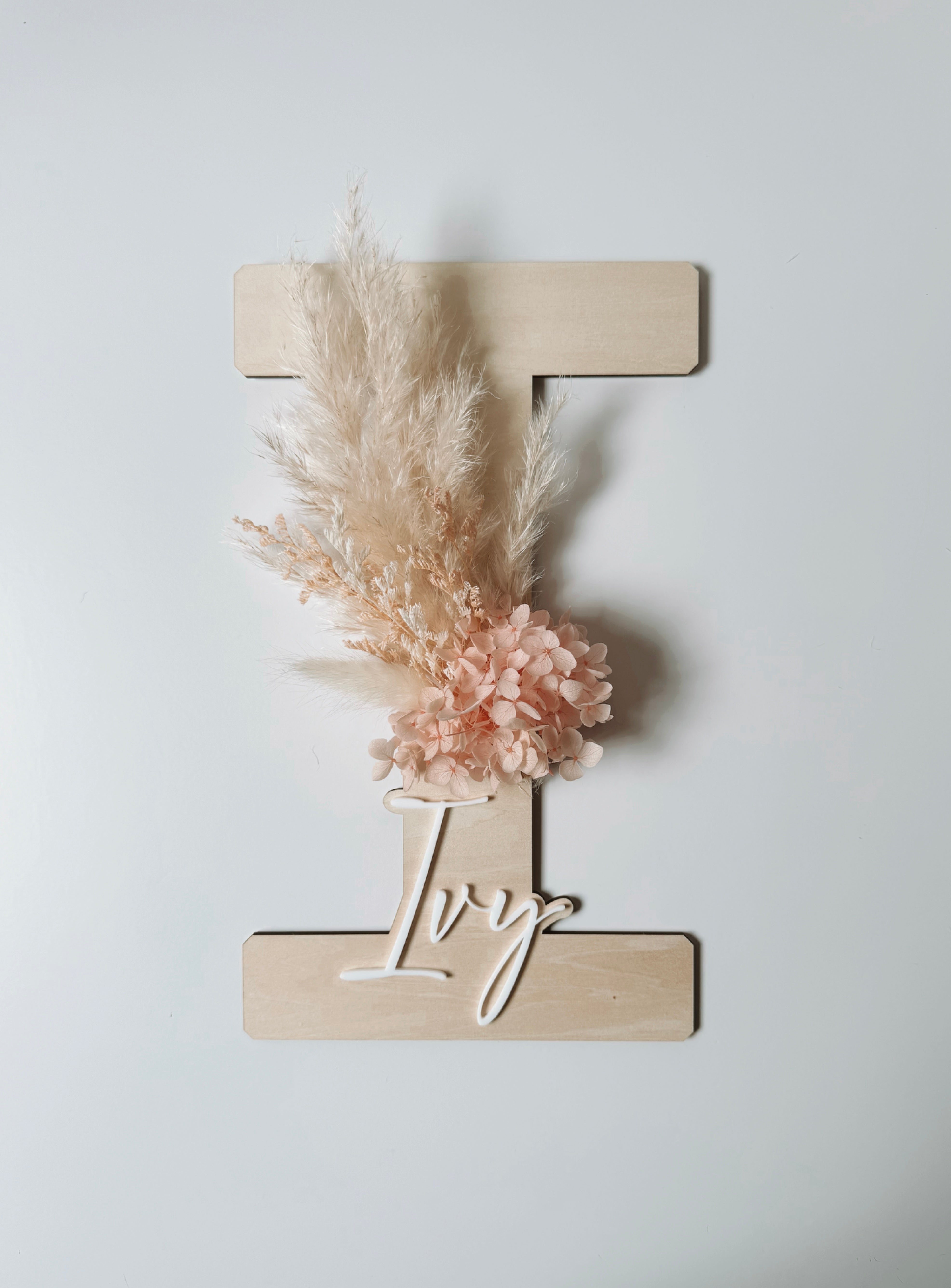 Dried floral wooden plaque with acrylic and/or laser engraved text or name, letter/initial, with dried preserved flowers tied to the plaque. Perfect for baby birth announcements or personalised gifts or keepsakes.