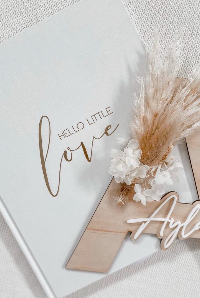 Dried floral wooden plaque with acrylic and/or laser engraved text or name, letter/initial, with dried preserved flowers tied to the plaque. Perfect for baby birth announcements or personalised gifts or keepsakes.