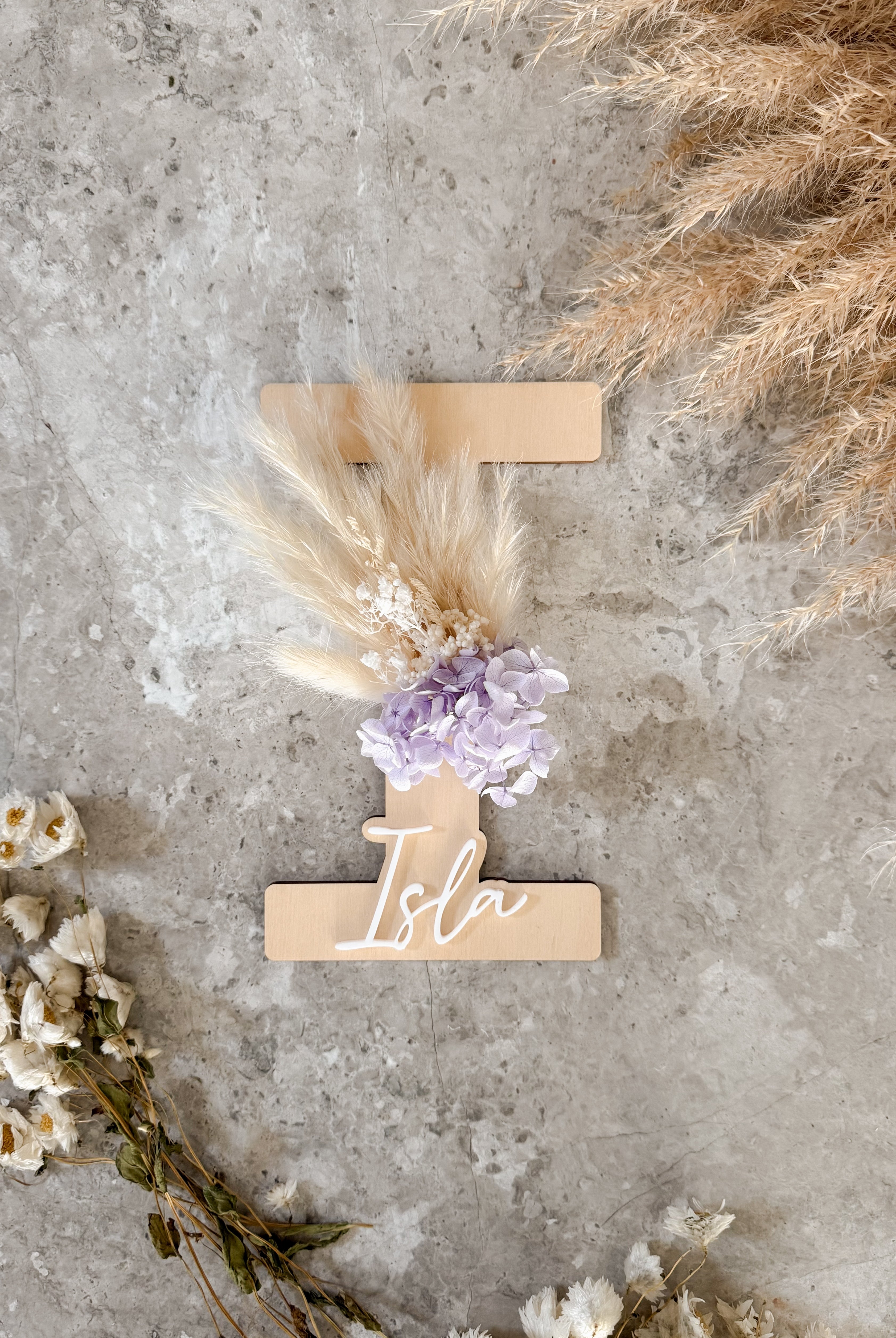 Dried floral wooden plaque with acrylic and/or laser engraved text or name, letter/initial, with dried preserved flowers tied to the plaque. Perfect for baby birth announcements or personalised gifts or keepsakes.
