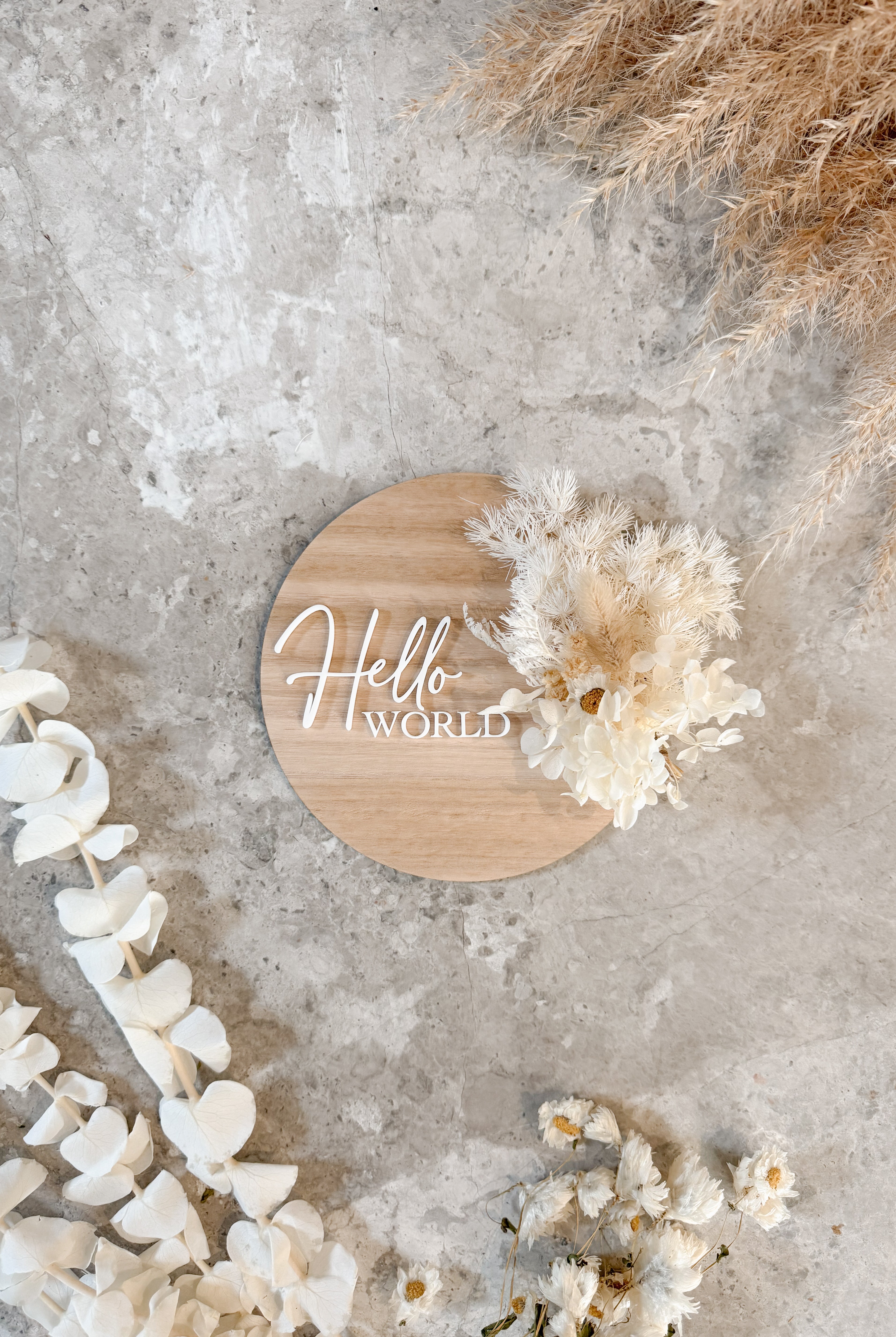 Dried floral wooden plaque with acrylic and/or laser engraved text or name, either arch or round shape, with dried preserved flowers tied to the plaque. Perfect for baby birth announcements or personalised gifts or keepsakes.