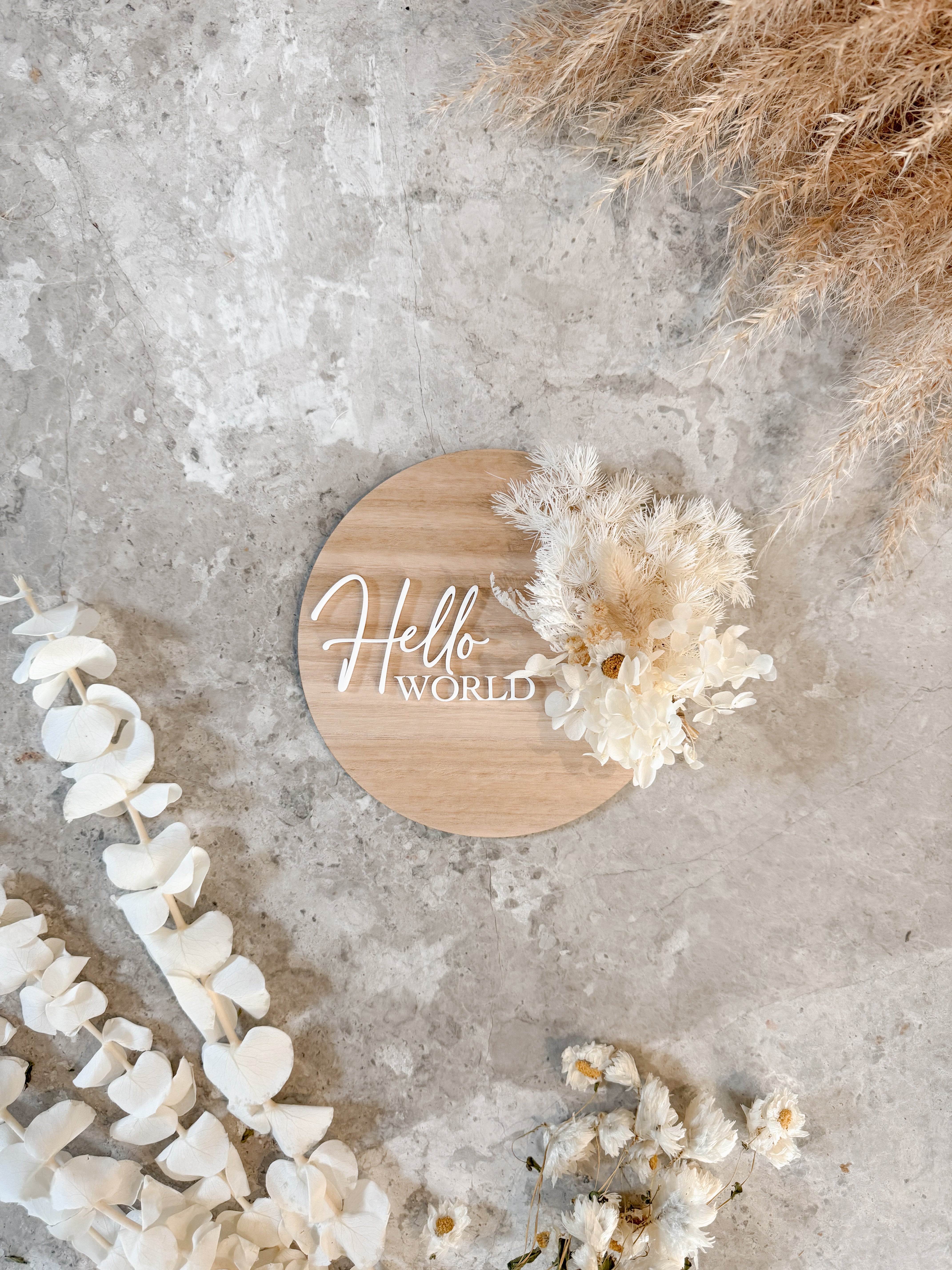 Dried floral wooden plaque with acrylic and/or laser engraved text or name, either arch or round shape, with dried preserved flowers tied to the plaque. Perfect for baby birth announcements or personalised gifts or keepsakes.