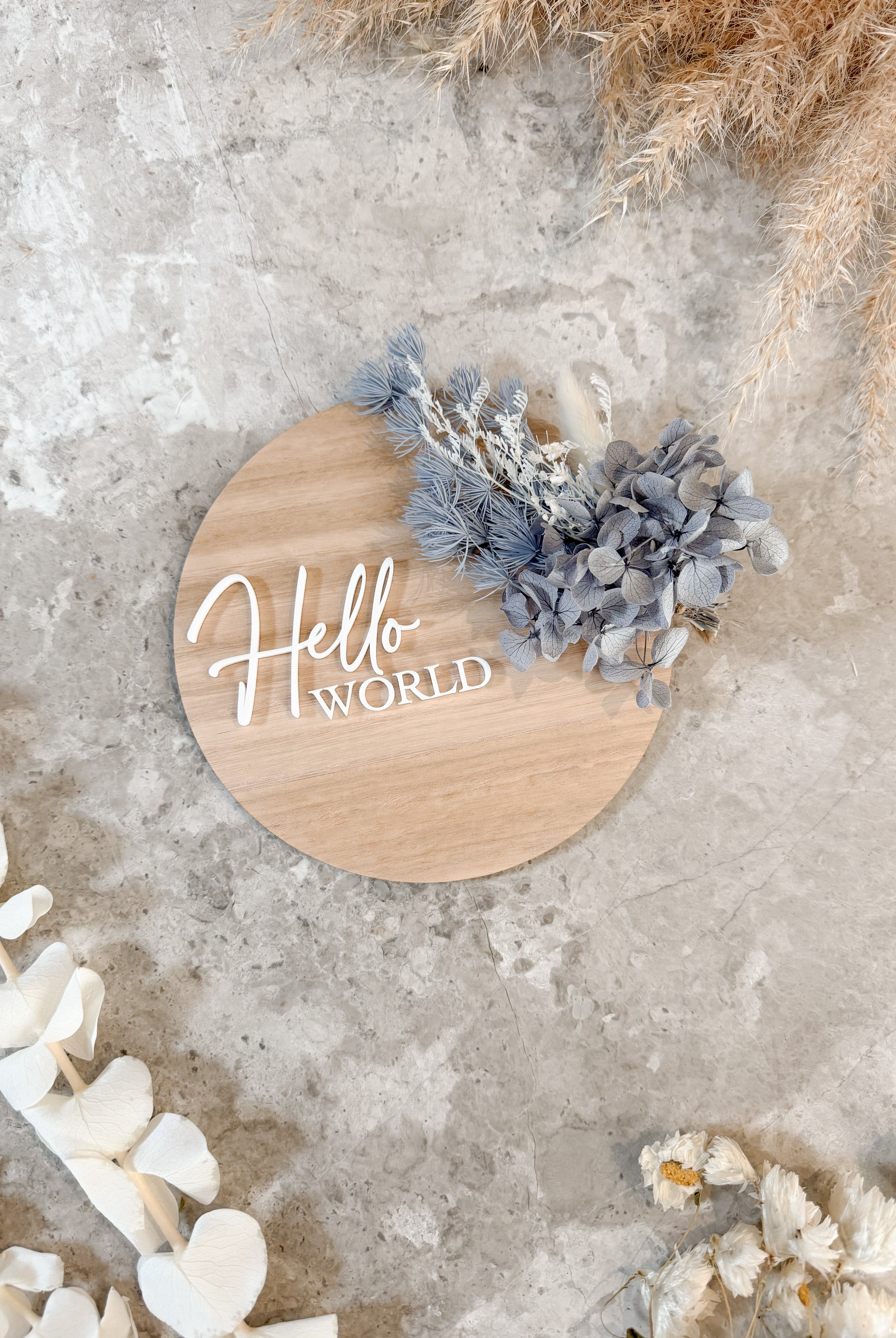 Dried floral wooden plaque with acrylic and/or laser engraved text or name, either arch or round shape, with dried preserved flowers tied to the plaque. Perfect for baby birth announcements or personalised gifts or keepsakes.