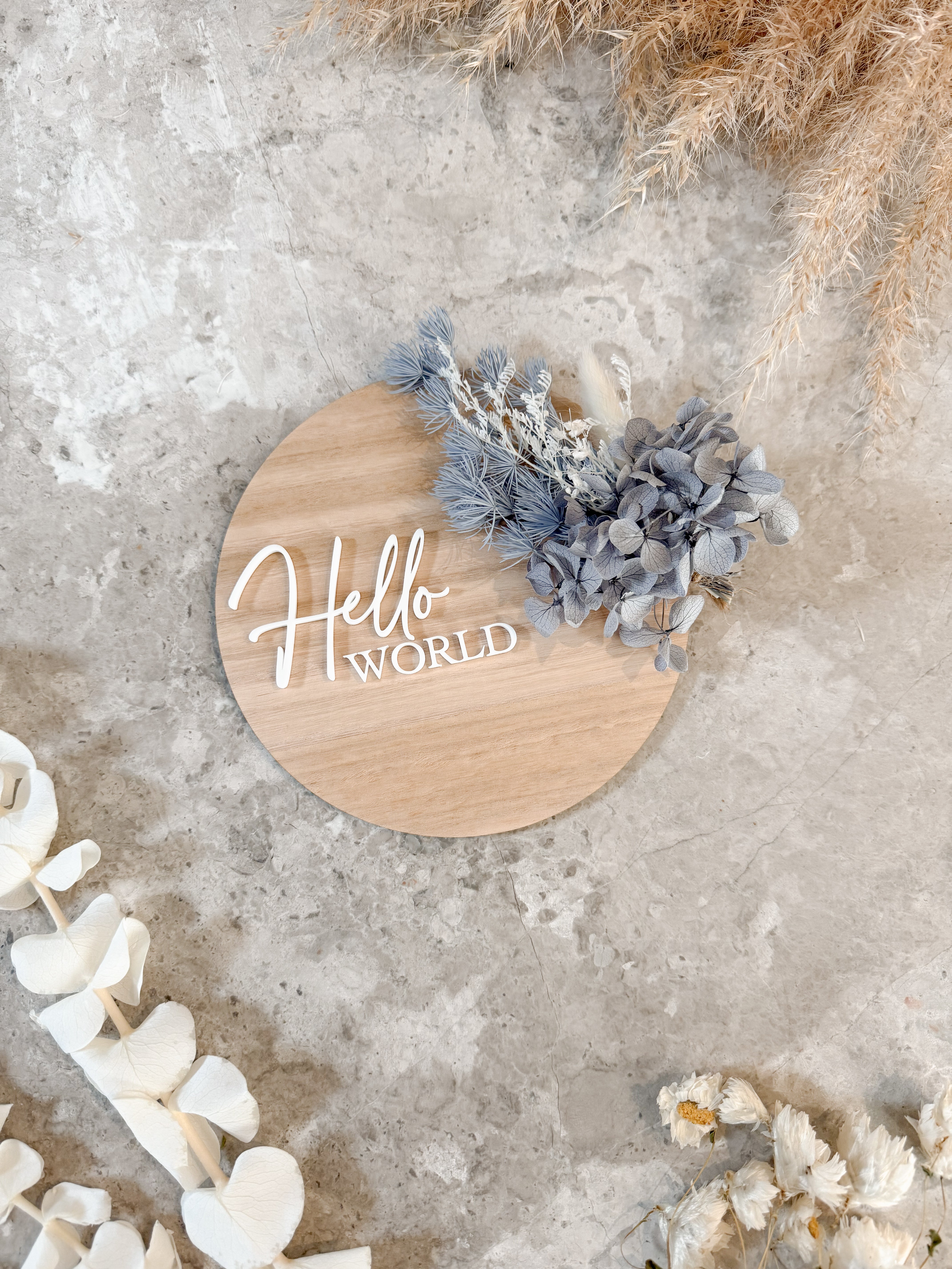 Dried floral wooden plaque with acrylic and/or laser engraved text or name, either arch or round shape, with dried preserved flowers tied to the plaque. Perfect for baby birth announcements or personalised gifts or keepsakes.
