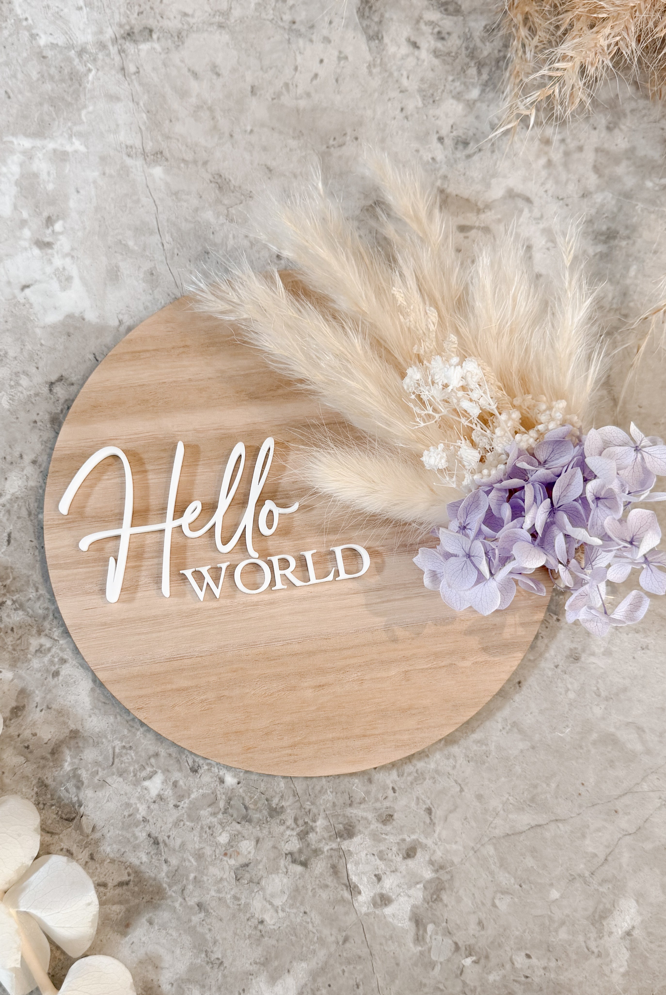 Dried floral wooden plaque with acrylic and/or laser engraved text or name, either arch or round shape, with dried preserved flowers tied to the plaque. Perfect for baby birth announcements or personalised gifts or keepsakes.