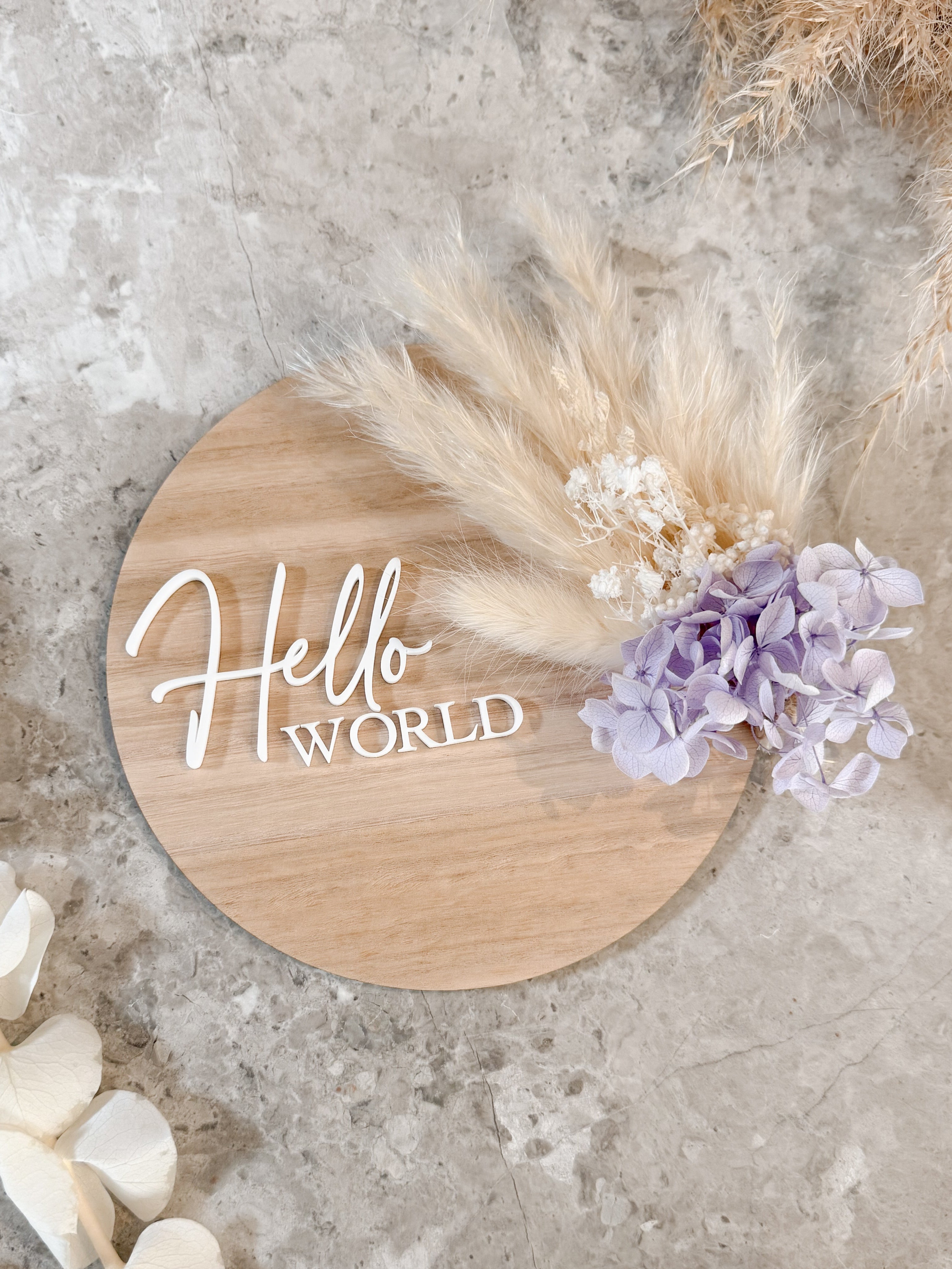 Dried floral wooden plaque with acrylic and/or laser engraved text or name, either arch or round shape, with dried preserved flowers tied to the plaque. Perfect for baby birth announcements or personalised gifts or keepsakes.