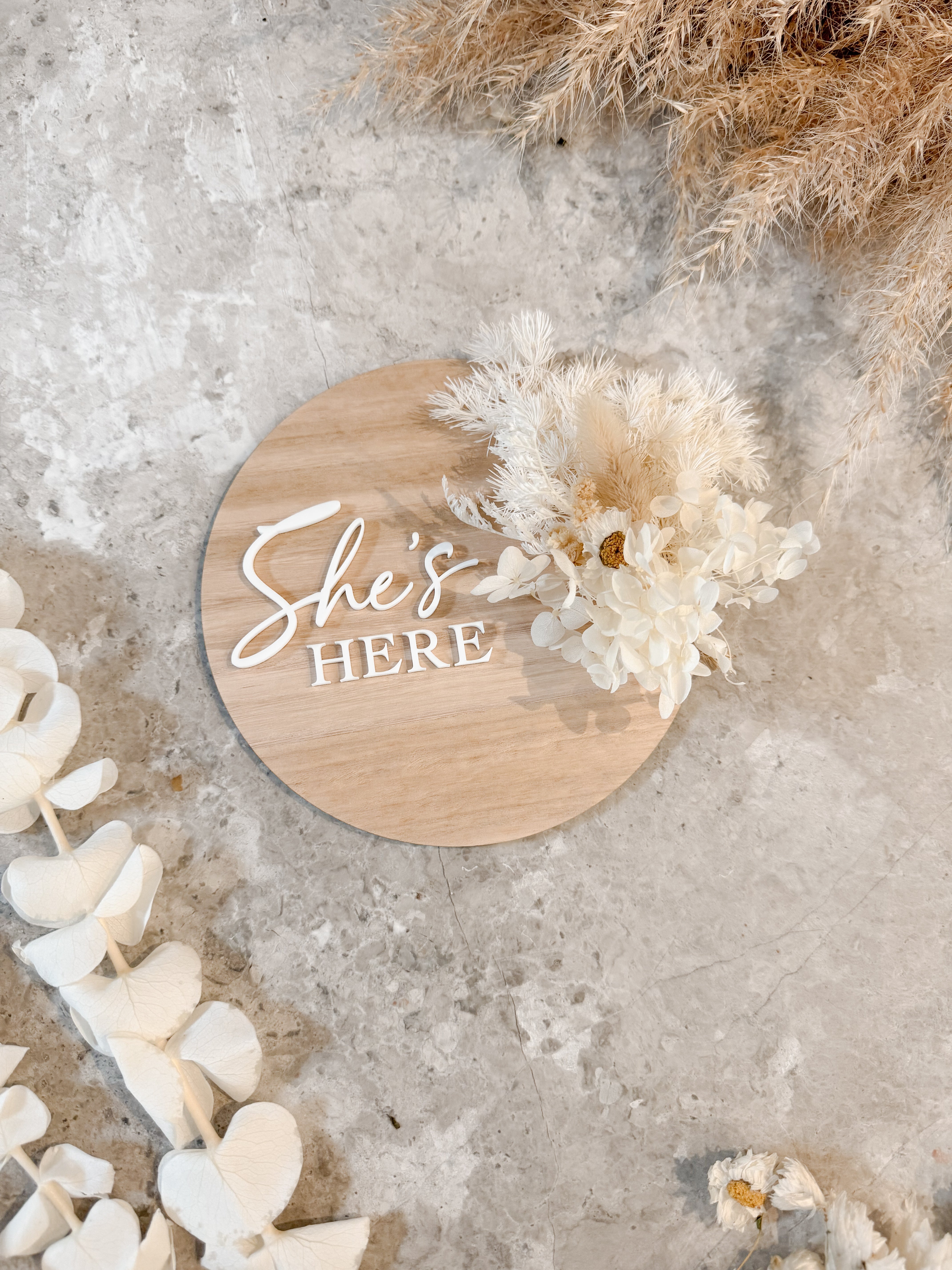 Dried floral wooden plaque with acrylic and/or laser engraved text or name, either arch or round shape, with dried preserved flowers tied to the plaque. Perfect for baby birth announcements or personalised gifts or keepsakes.