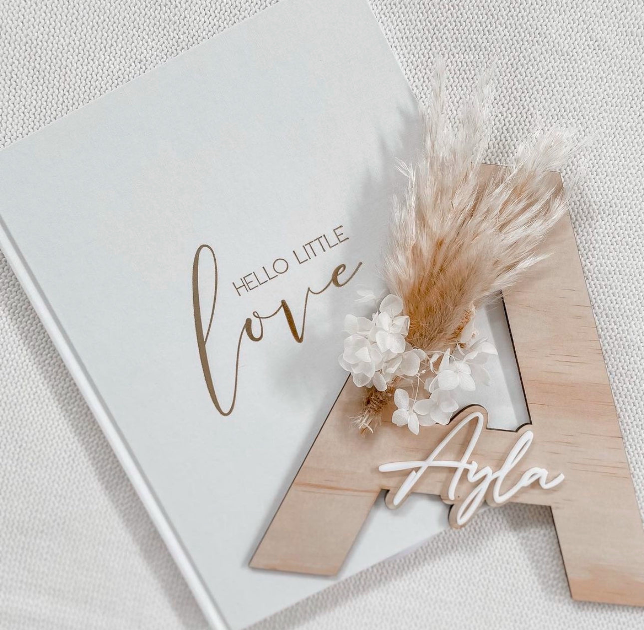 Dried floral wooden plaque with acrylic and/or laser engraved text or name, letter/initial, with dried preserved flowers tied to the plaque. Perfect for baby birth announcements or personalised gifts or keepsakes.