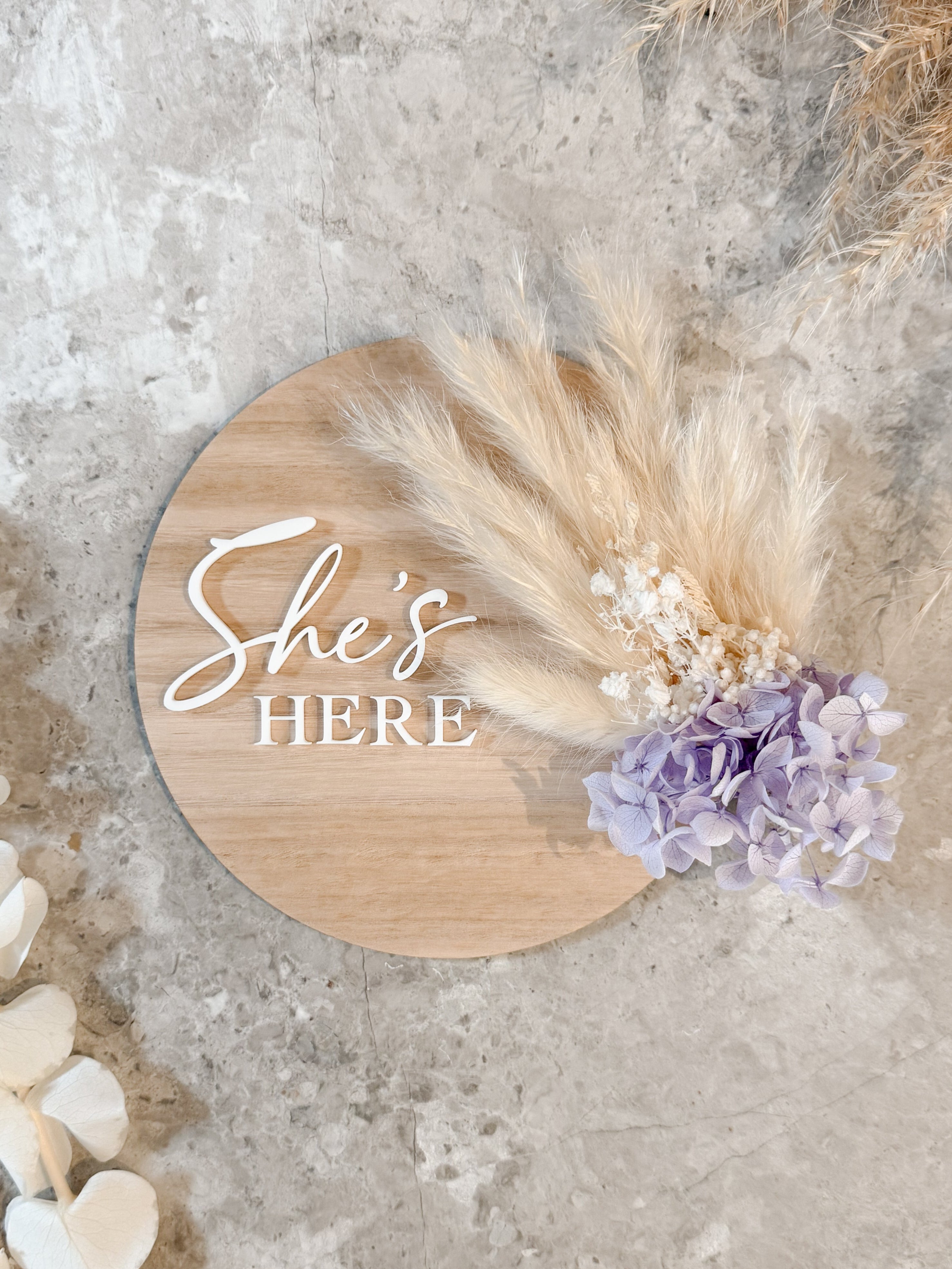 Dried floral wooden plaque with acrylic and/or laser engraved text or name, either arch or round shape, with dried preserved flowers tied to the plaque. Perfect for baby birth announcements or personalised gifts or keepsakes.